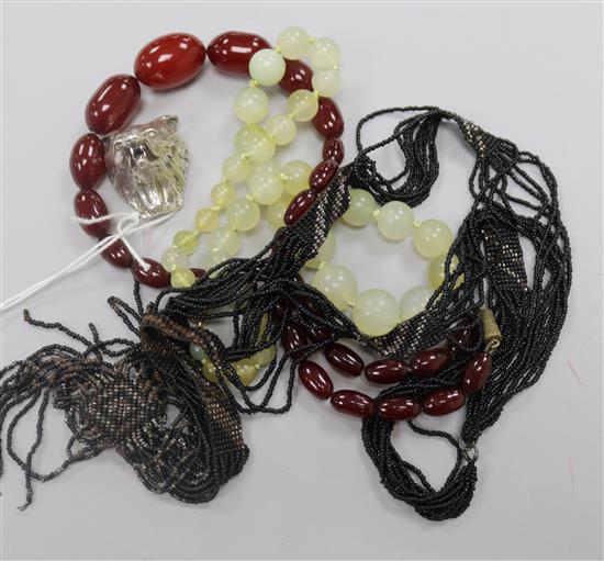 A 1990s silver foxs head pill box and three necklaces including simulated cherry amber.